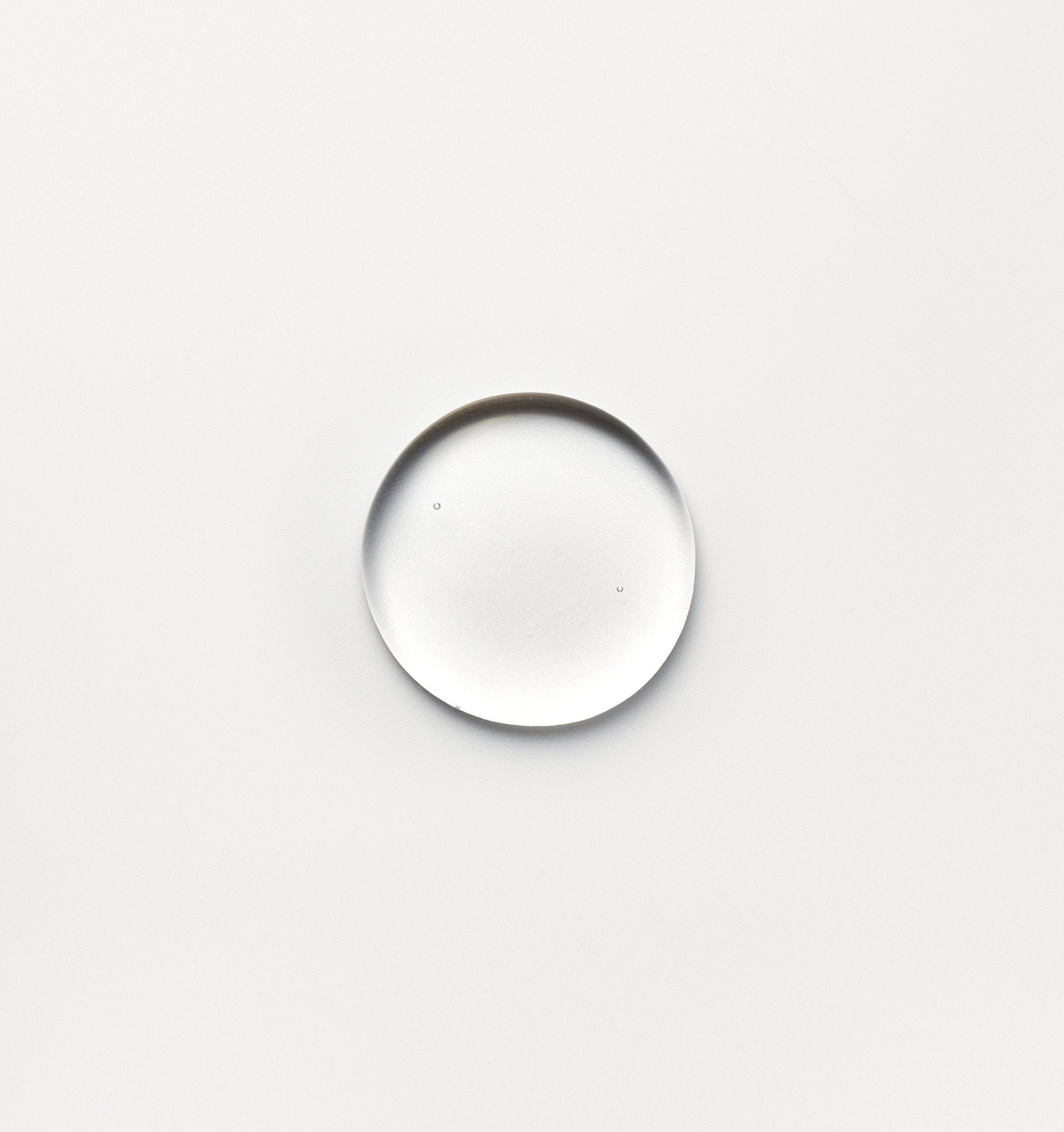 a macro shot of a single dot of fjör hydrolytic serum with a white background
