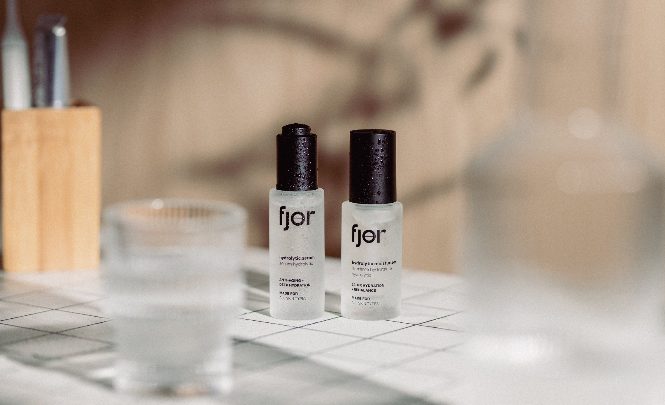 two bottles of fjör hydrolytic products on a bathroom counter