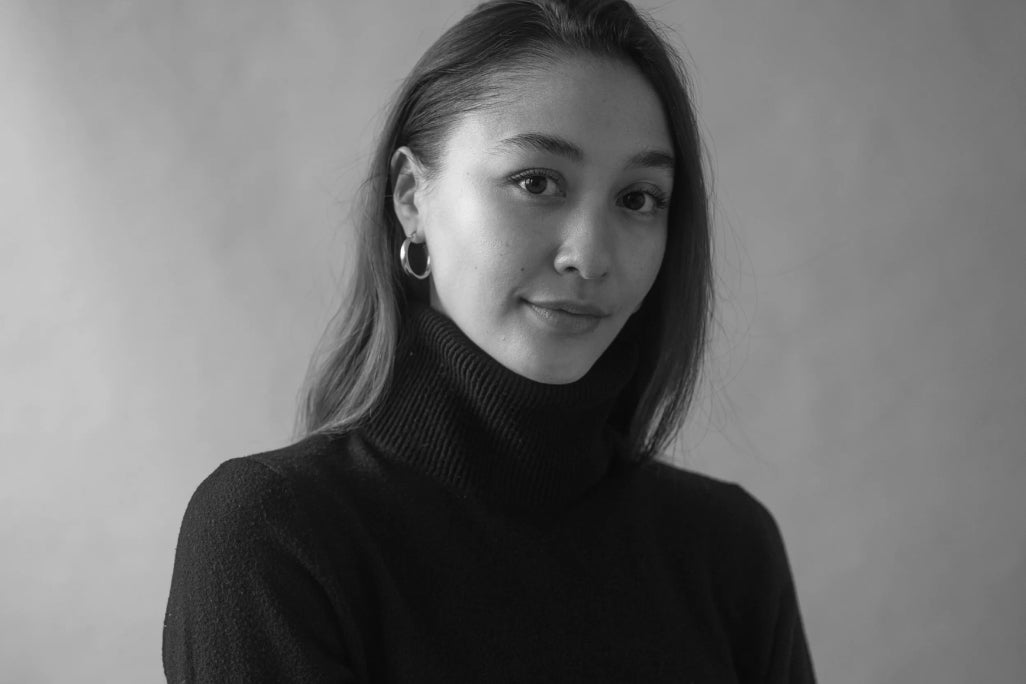 a black and white portrait of Natalie Enslow the founder of fjor on a plain backdrop wearing a turtle neck sweater
